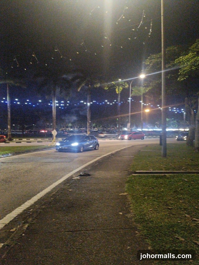 Nighttime street scene with cars and lights