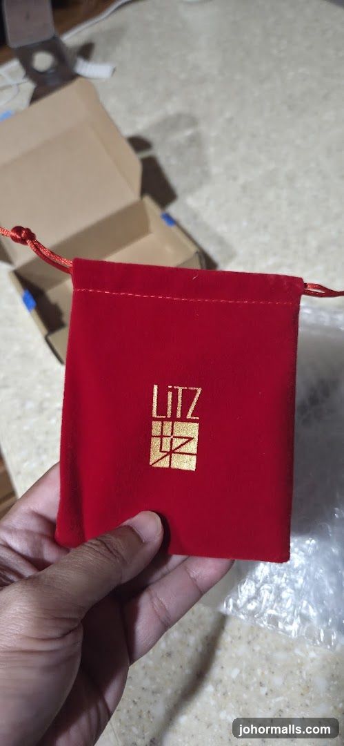 Red velvet pouch with gold logo