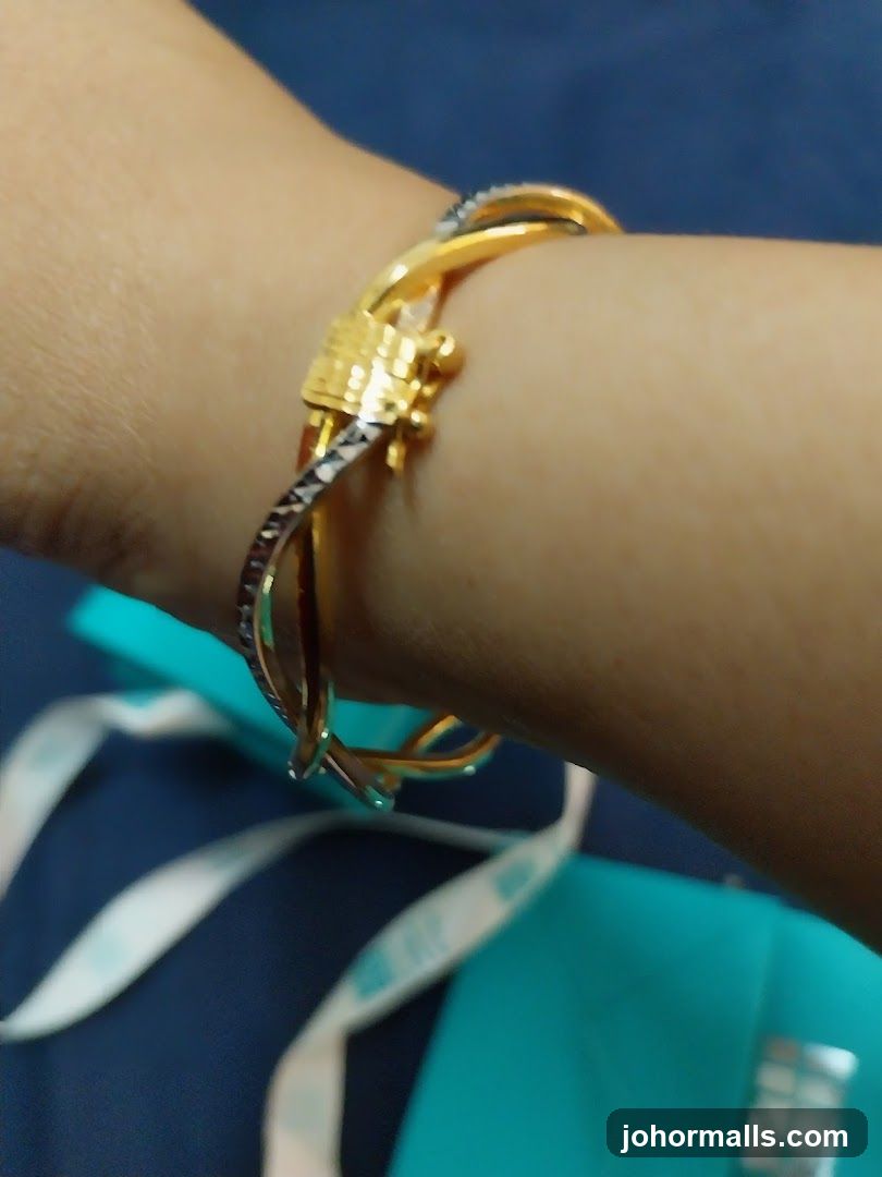 Gold and silver-toned bracelet on a wrist