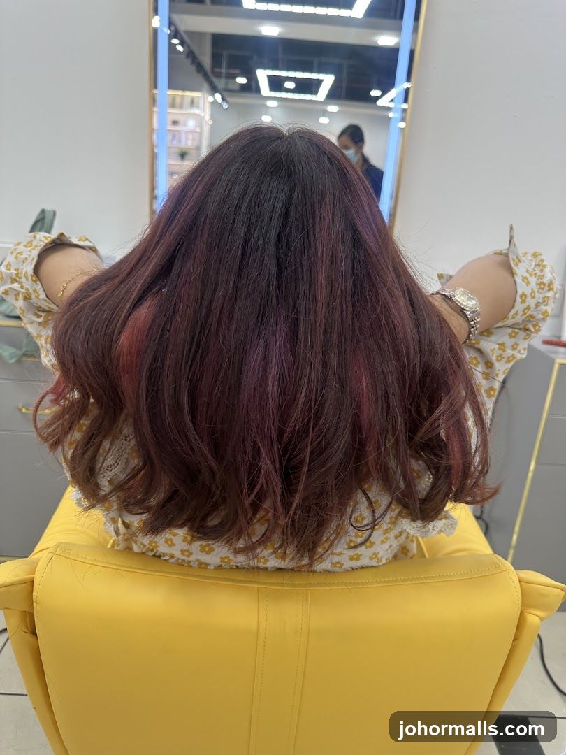 Woman with dyed hair sitting in a salon chair