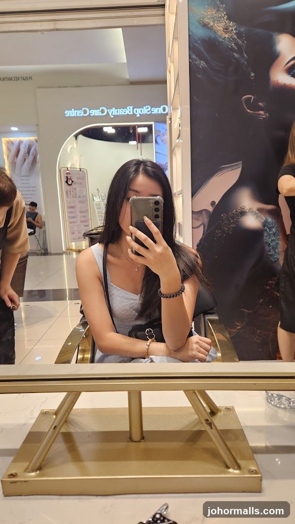 Woman taking a selfie in a beauty salon