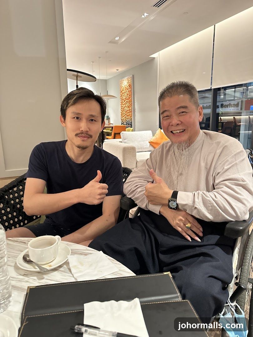 Two men giving thumbs up in a cafe
