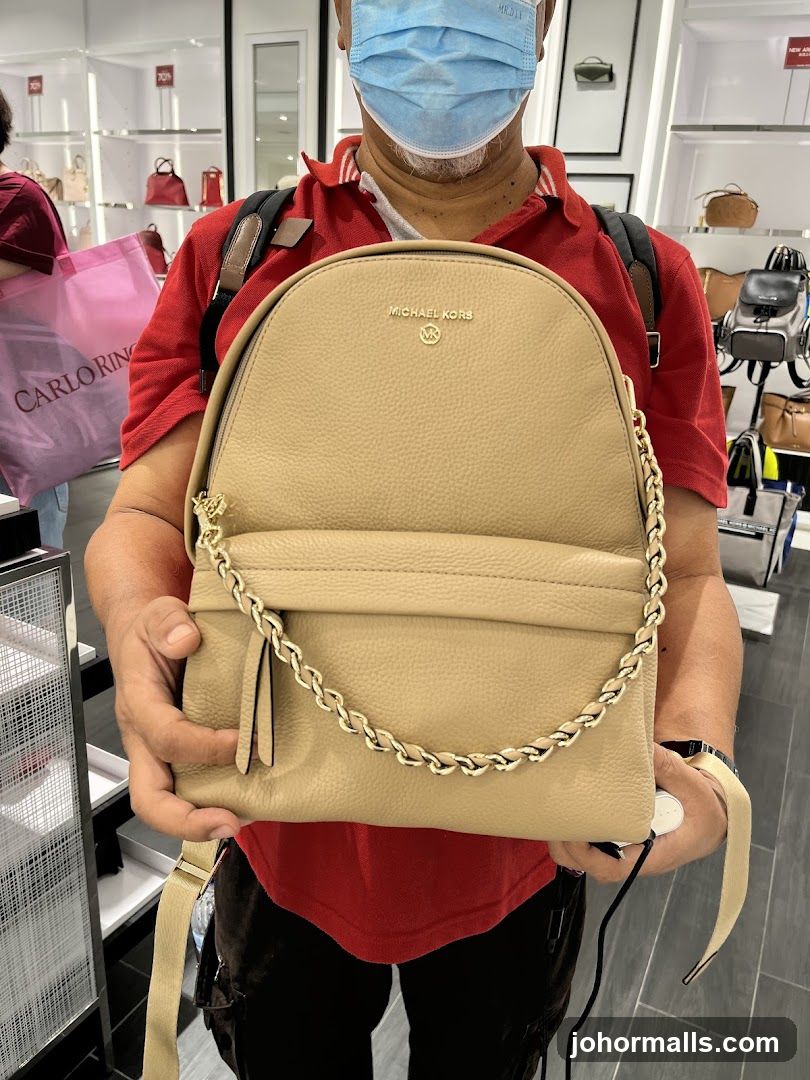 Man Holding Michael Kors Backpack