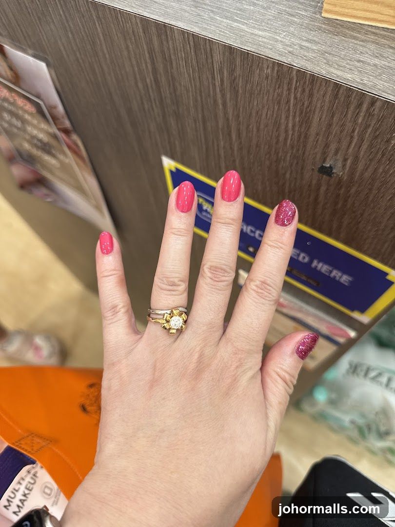 Woman's Hand with Pink Nails and Ring