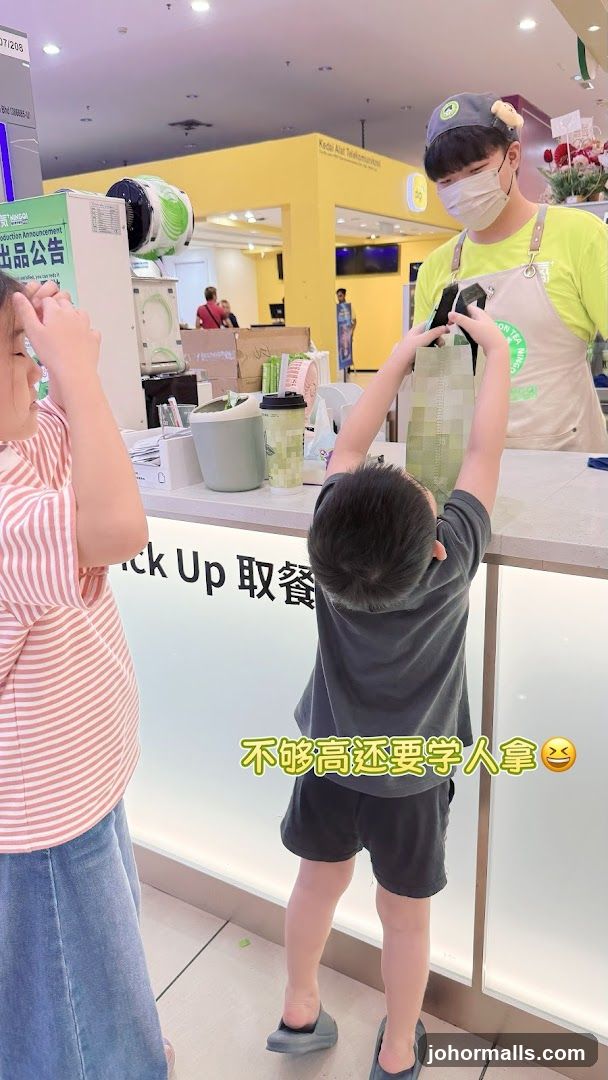 Children reaching for a bag at a counter