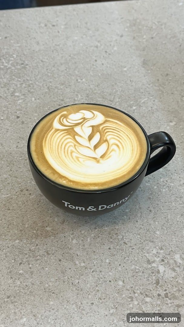 Latte art in a black mug