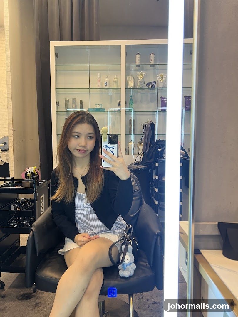 Woman taking a selfie in a salon