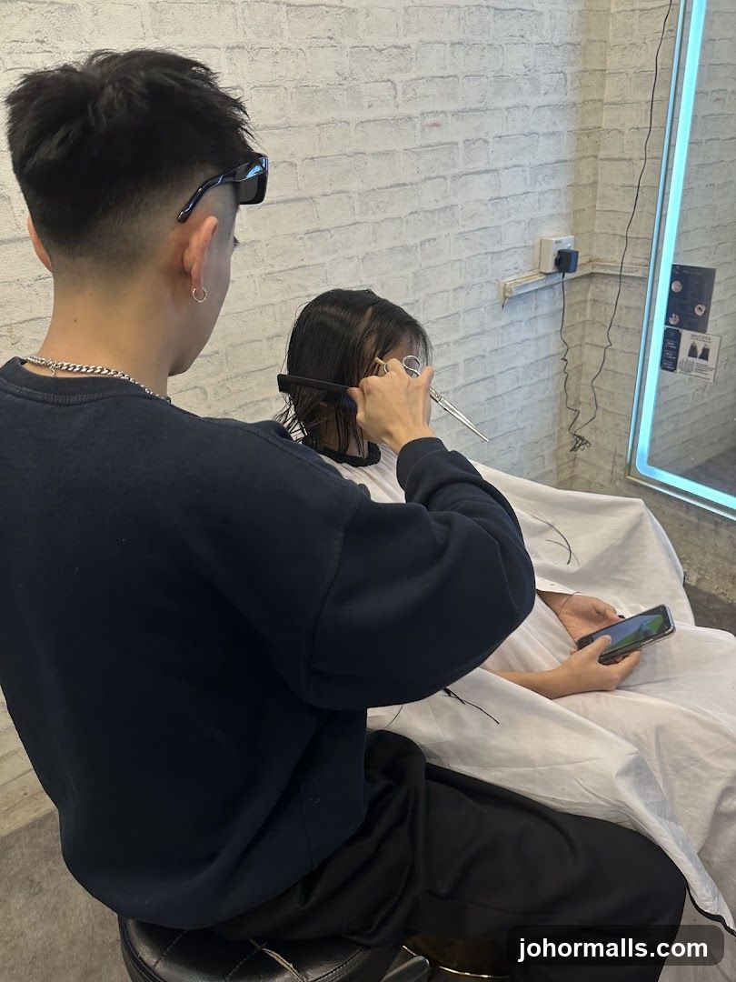 Hairdresser cutting client's hair