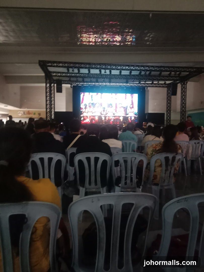 Audience watching a performance on a large screen
