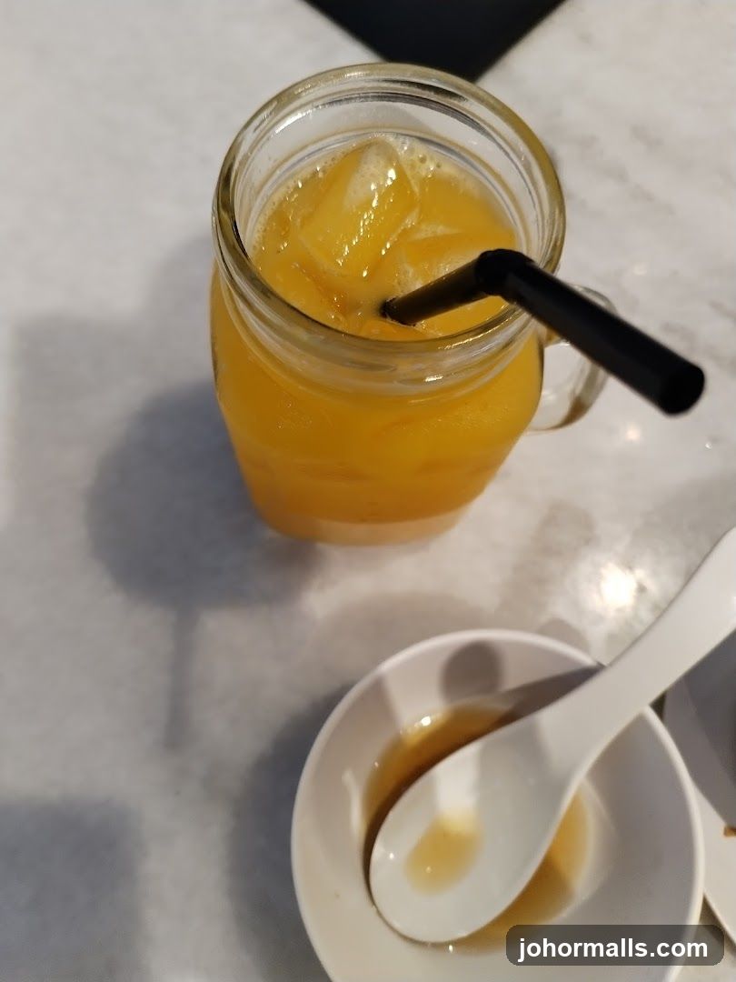 Orange Juice with Ice and Small Bowl with Spoon