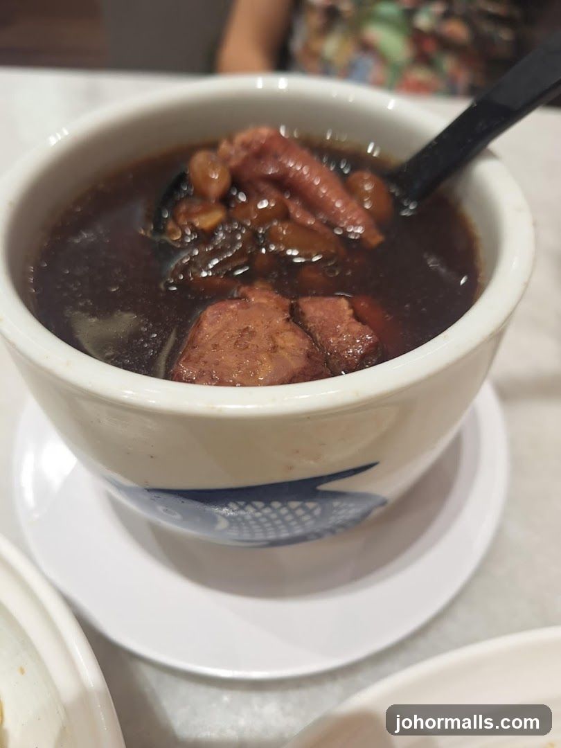 Bowl of soup with chicken feet and meat