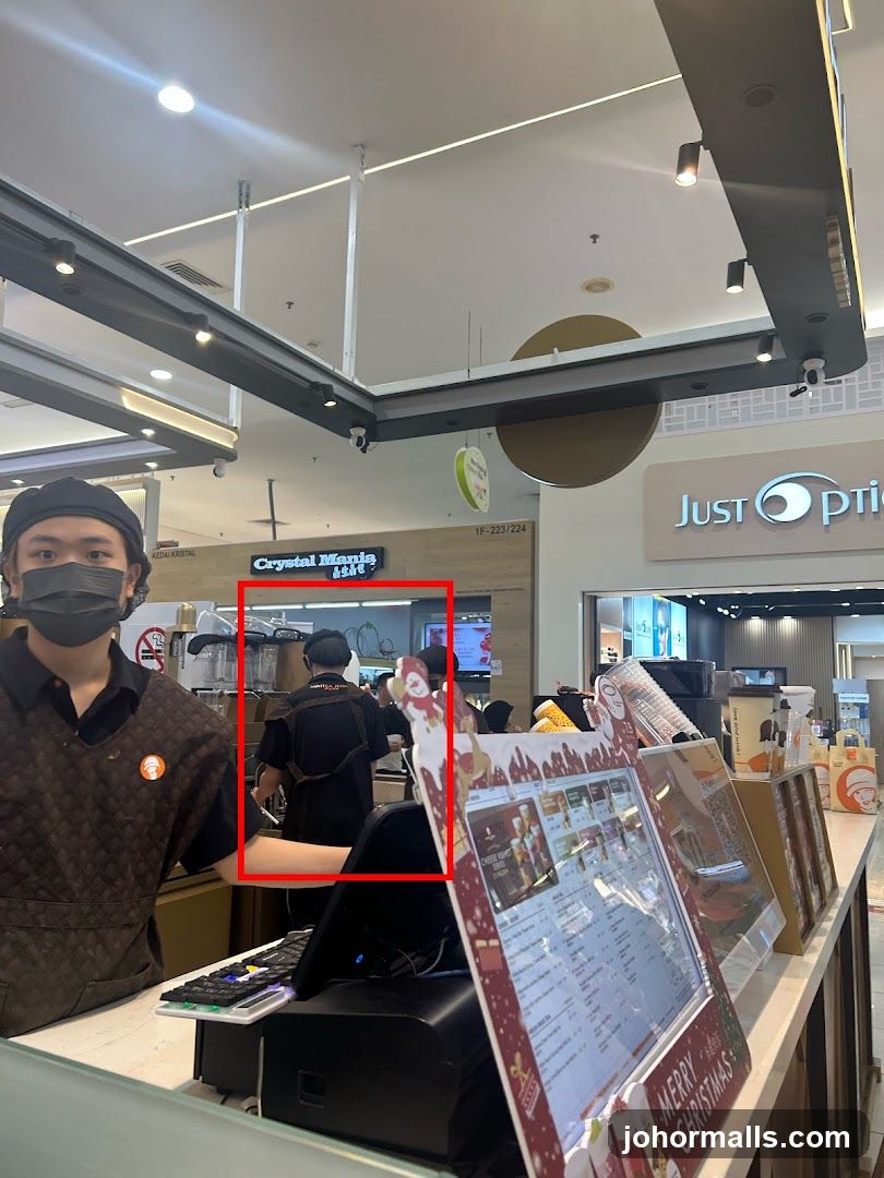 Staff at a counter with a menu display