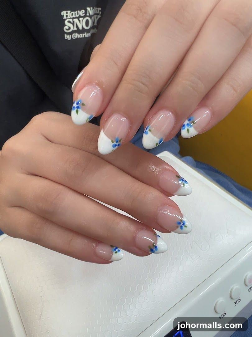 French Manicure with Blue Floral Accents