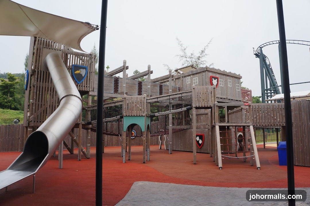 Outdoor Playground with Roller Coaster in Background
