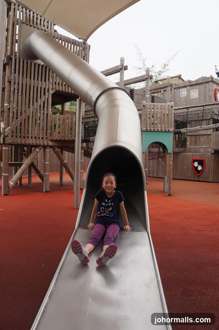 Girl on a playground slide