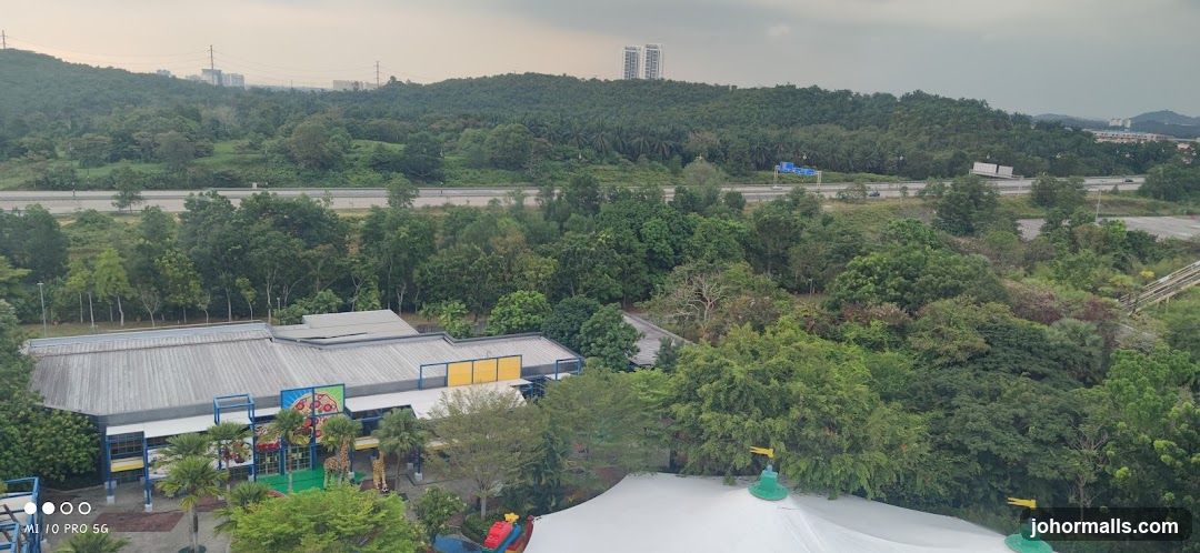 Amusement park with surrounding greenery and highway