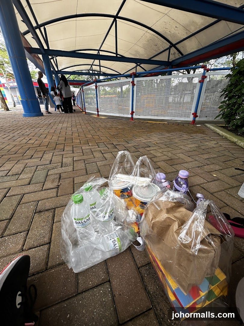 Bags of drinks and food on a paved walkway