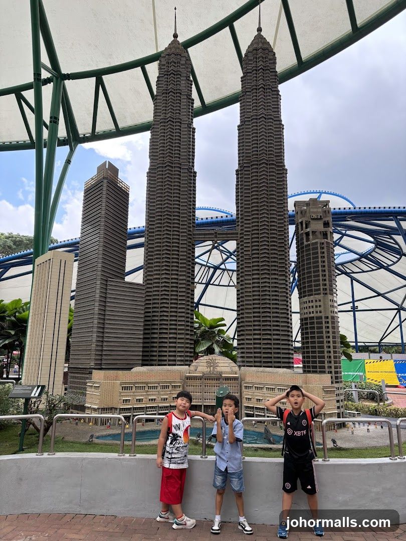 Children Posing in Front of Miniature Skyscrapers