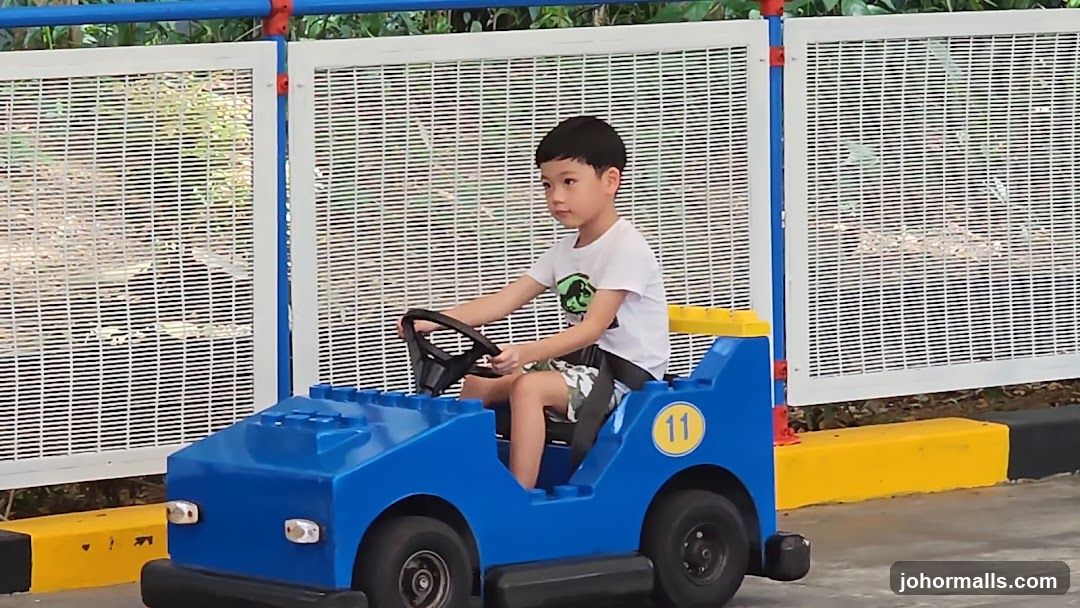 Boy driving a toy car