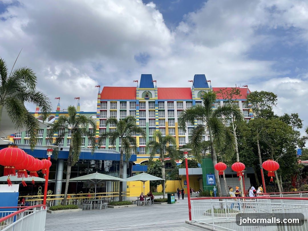Colorful Hotel Building with Palm Trees and Red Lanterns