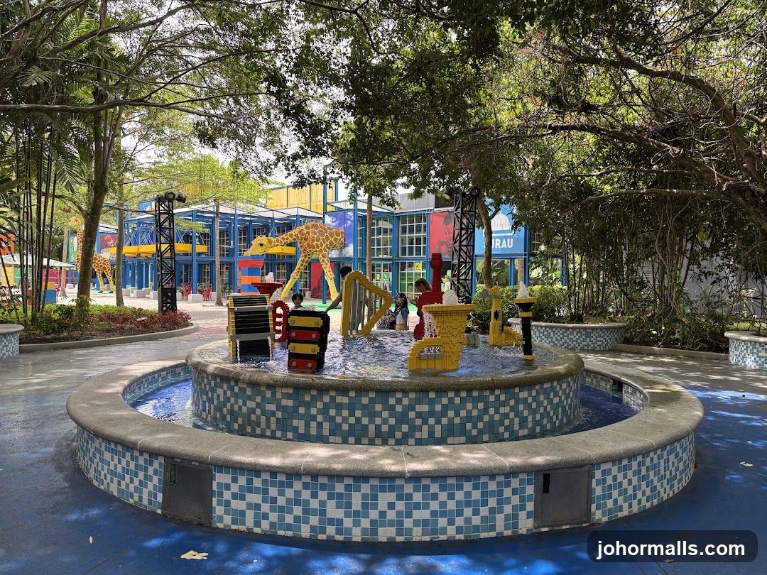 LEGO-themed water play area with giraffe sculptures