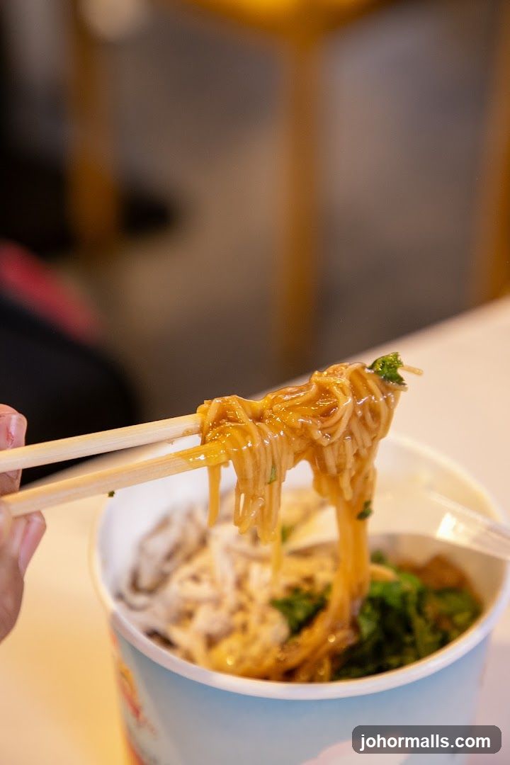 Noodles being lifted with chopsticks