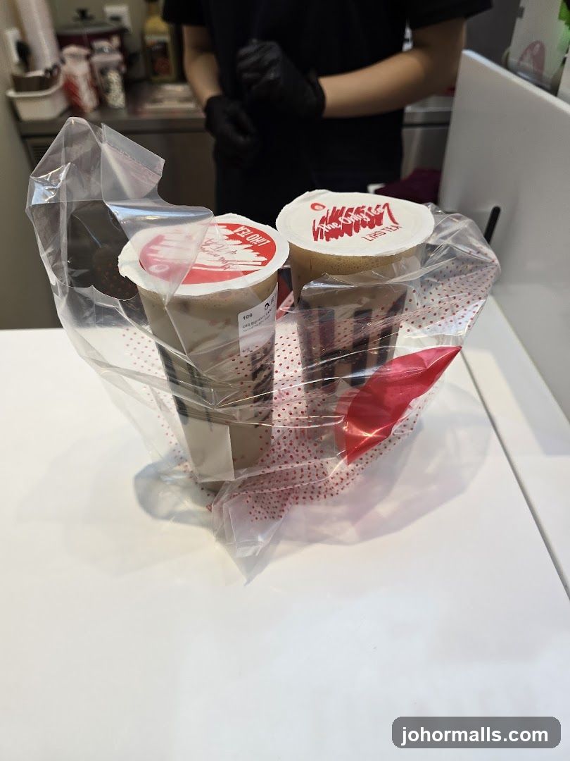 Two bubble tea drinks in a plastic bag