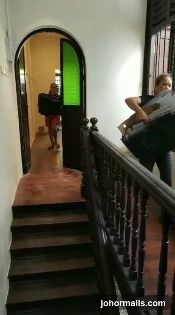 People carrying boxes up stairs