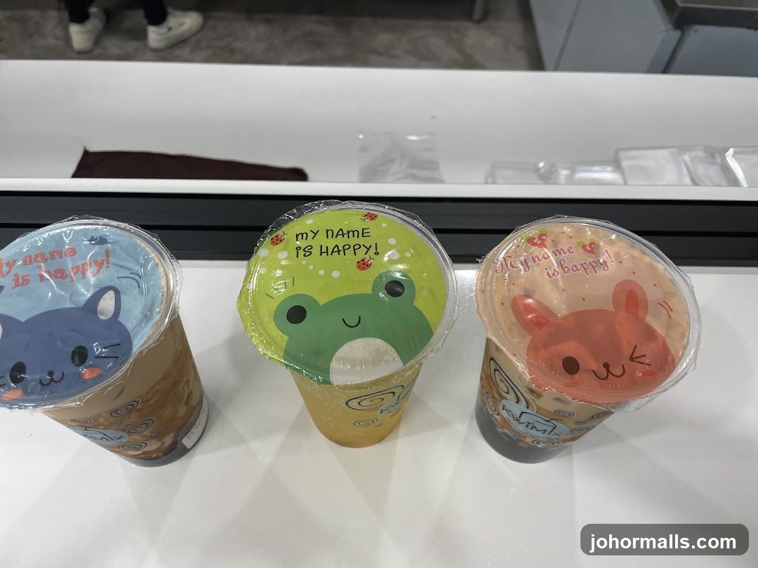 Three drinks with cartoon animal lids