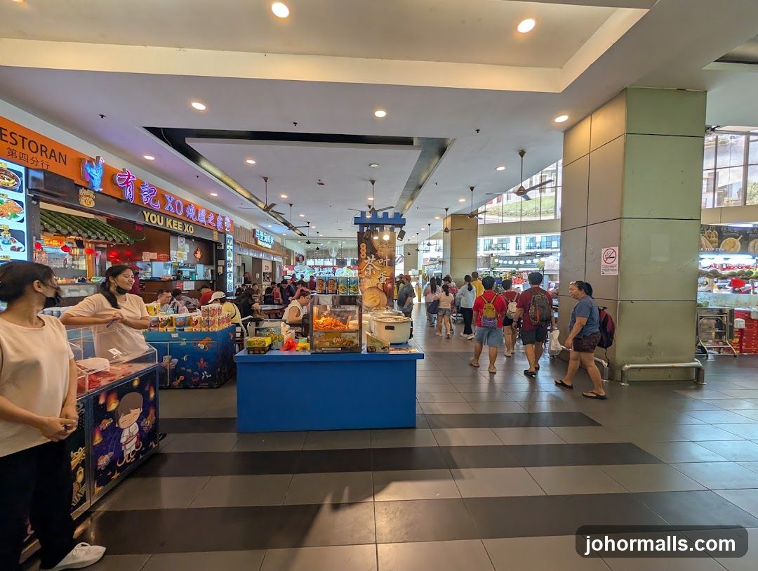 Food court with various stalls and people