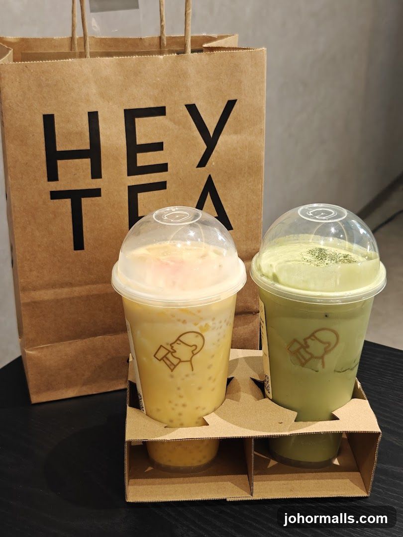 Two bubble tea drinks and a shopping bag