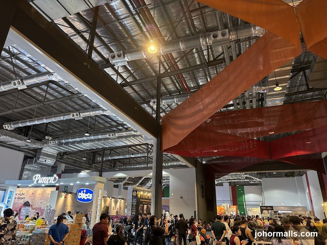 Busy Exhibition Hall with Booths and Crowds