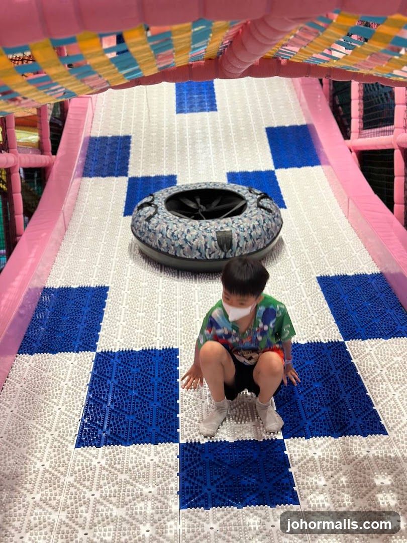 Child on a Slide at an Indoor Playground