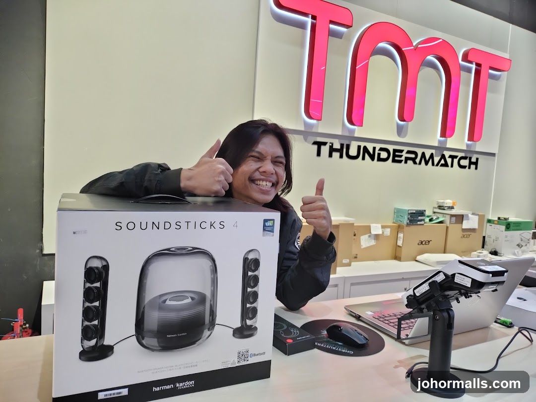 Person with Harman Kardon Soundsticks 4