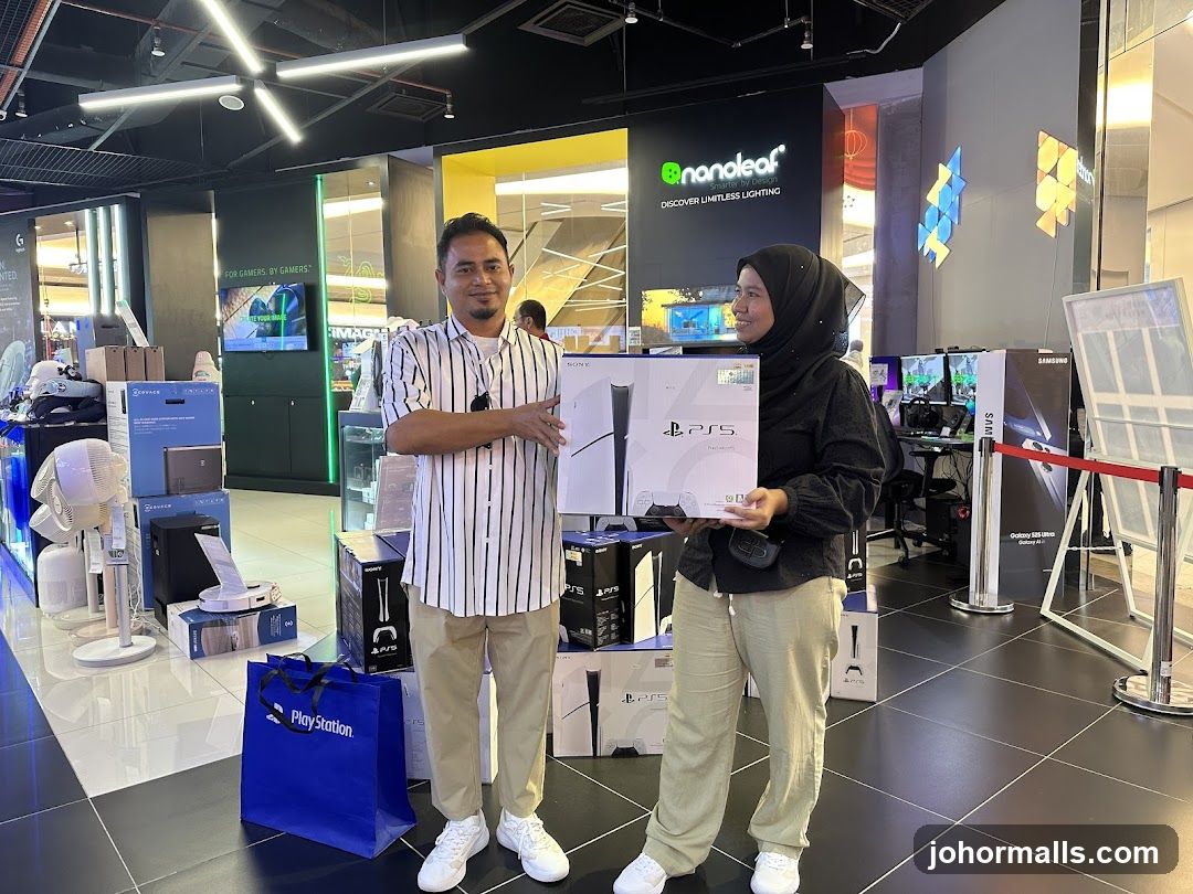 Two people holding a PlayStation 5 box