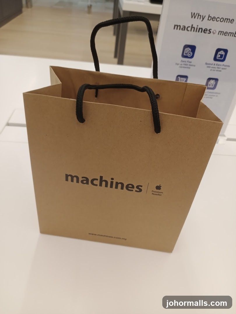 Brown paper shopping bag with "machines" logo