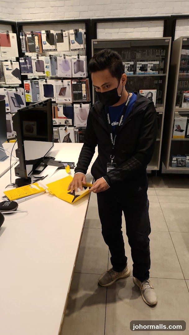 Store employee handling a yellow bag