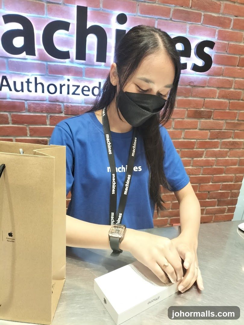Sales Associate with iPhone Box