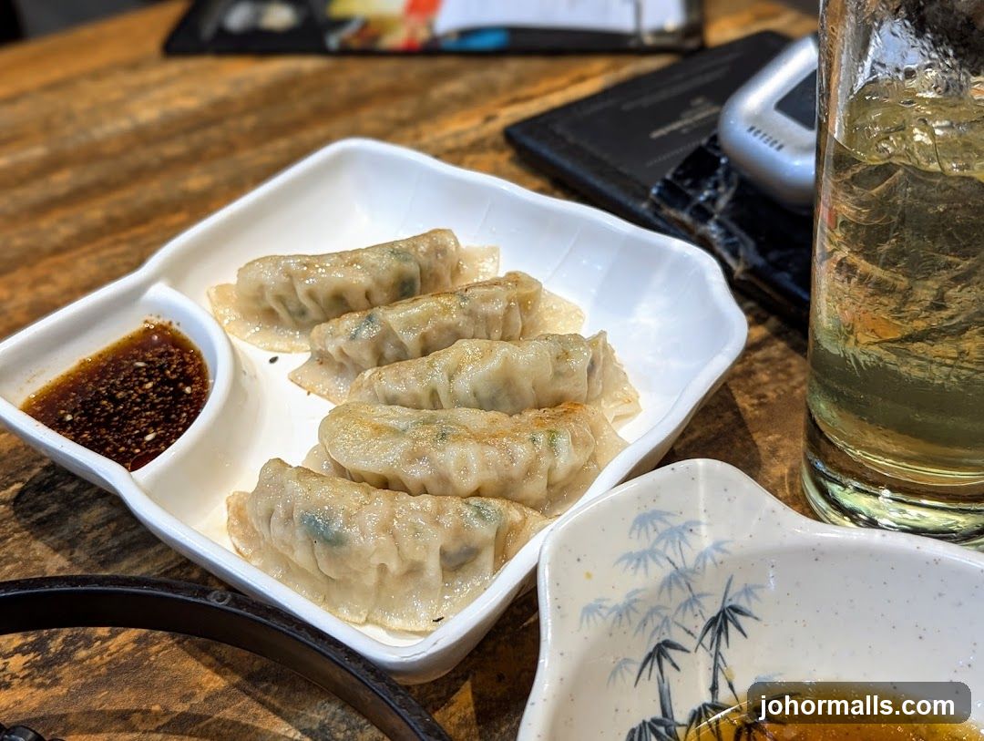 Pan-fried dumplings with dipping sauce
