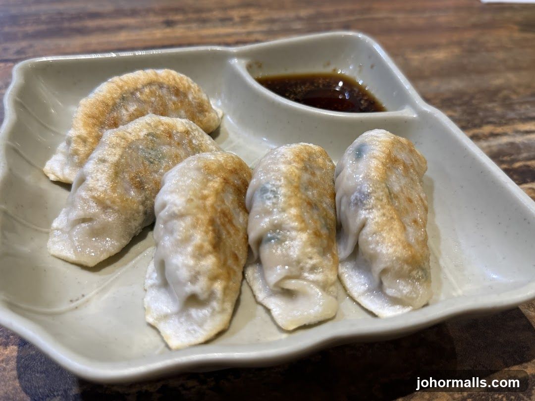 Pan-fried dumplings with dipping sauce