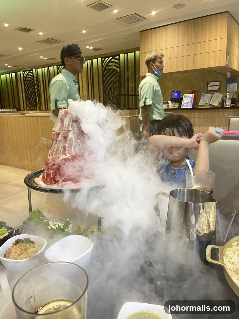 Diners enjoying a meal with a dramatic presentation