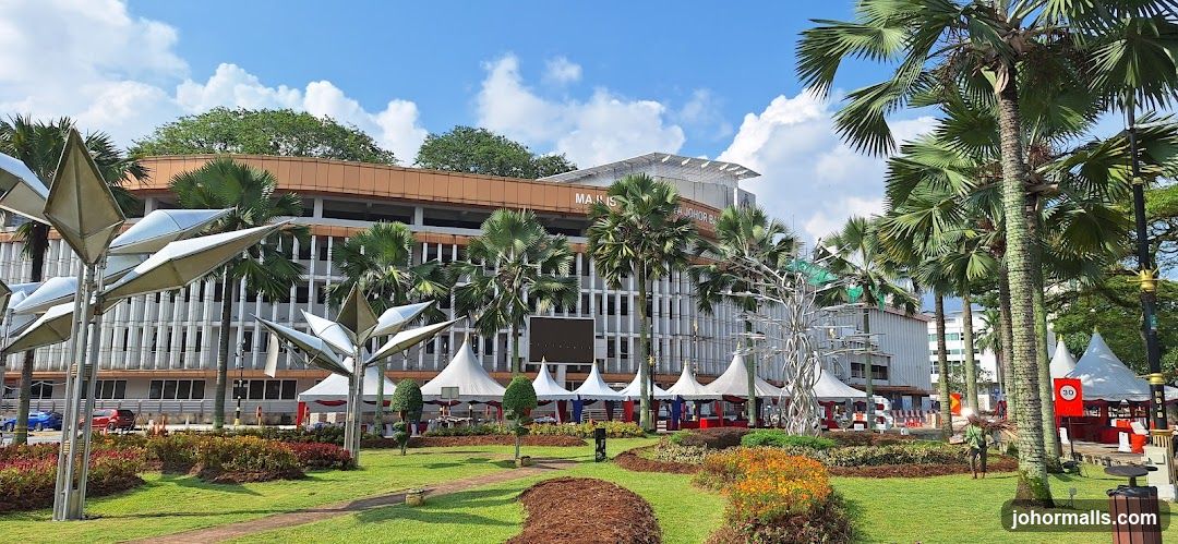 Outdoor event with tents and palm trees