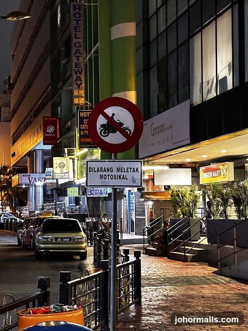 Street scene at night with hotel and shops