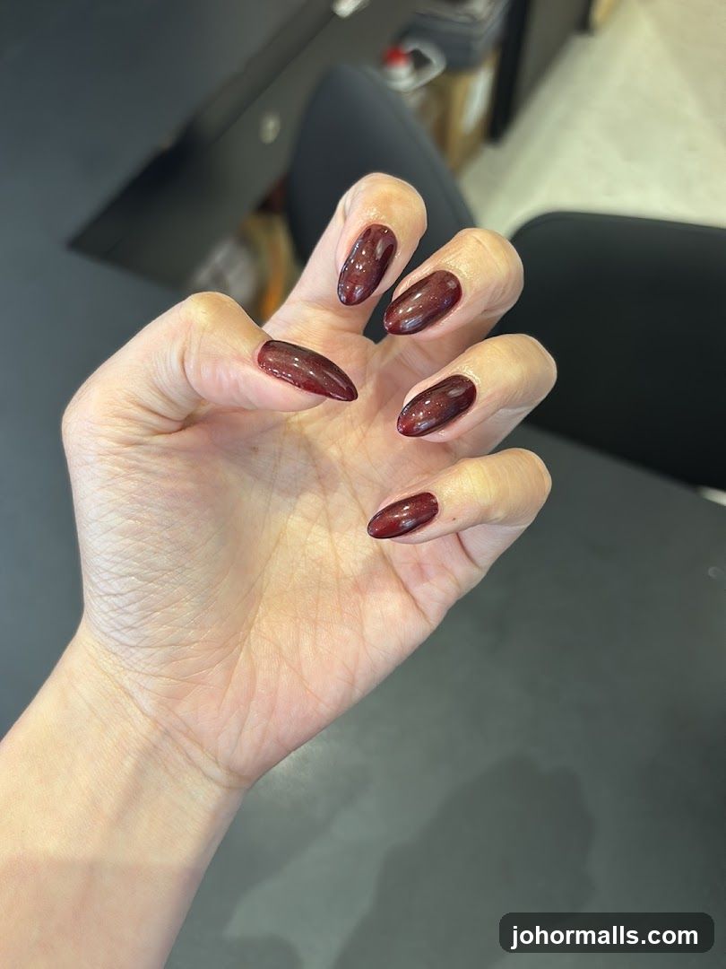Woman's Hand with Burgundy Nails