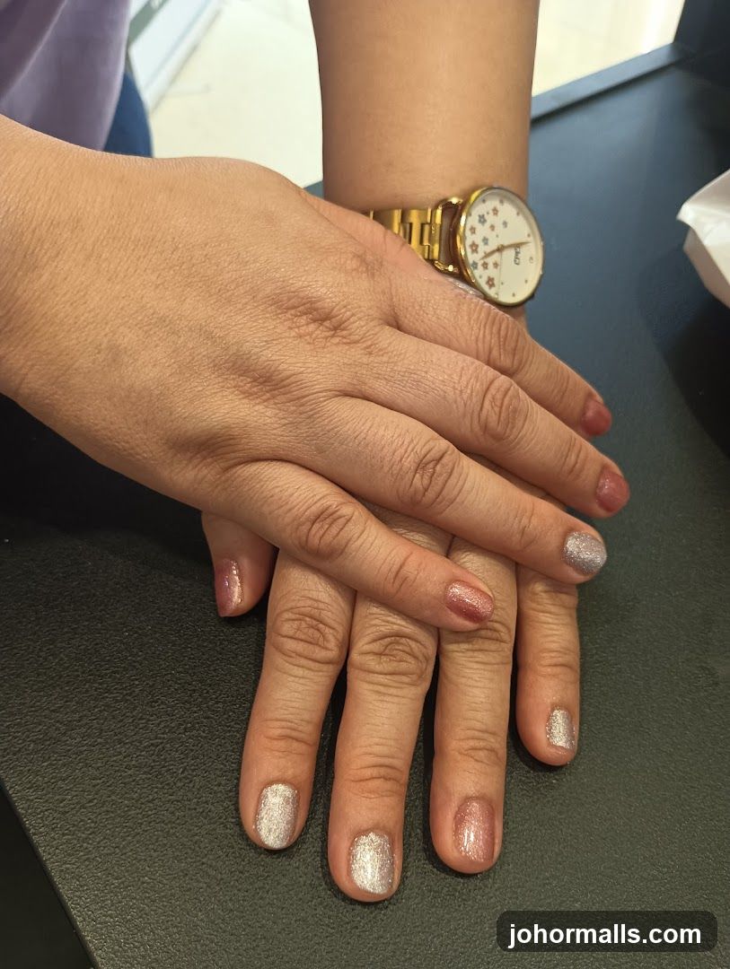 Hands with manicured nails and a watch