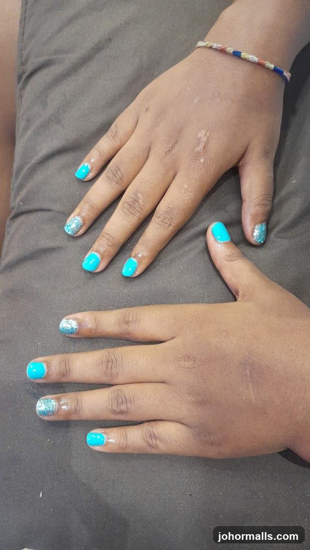 Hands with Blue and Glitter Nail Polish