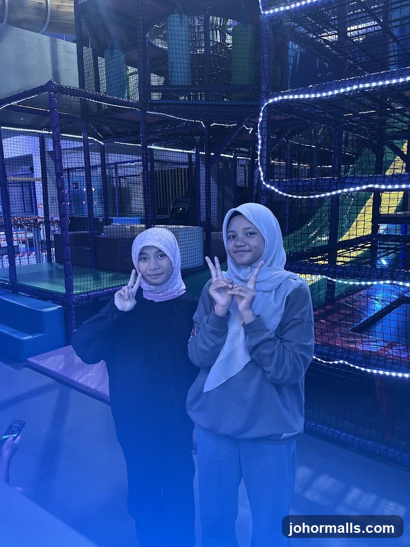Two girls posing in an indoor playground