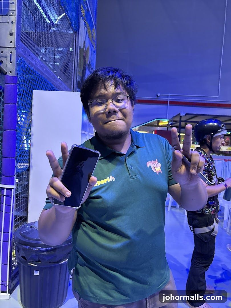 Man holding a phone and making peace signs