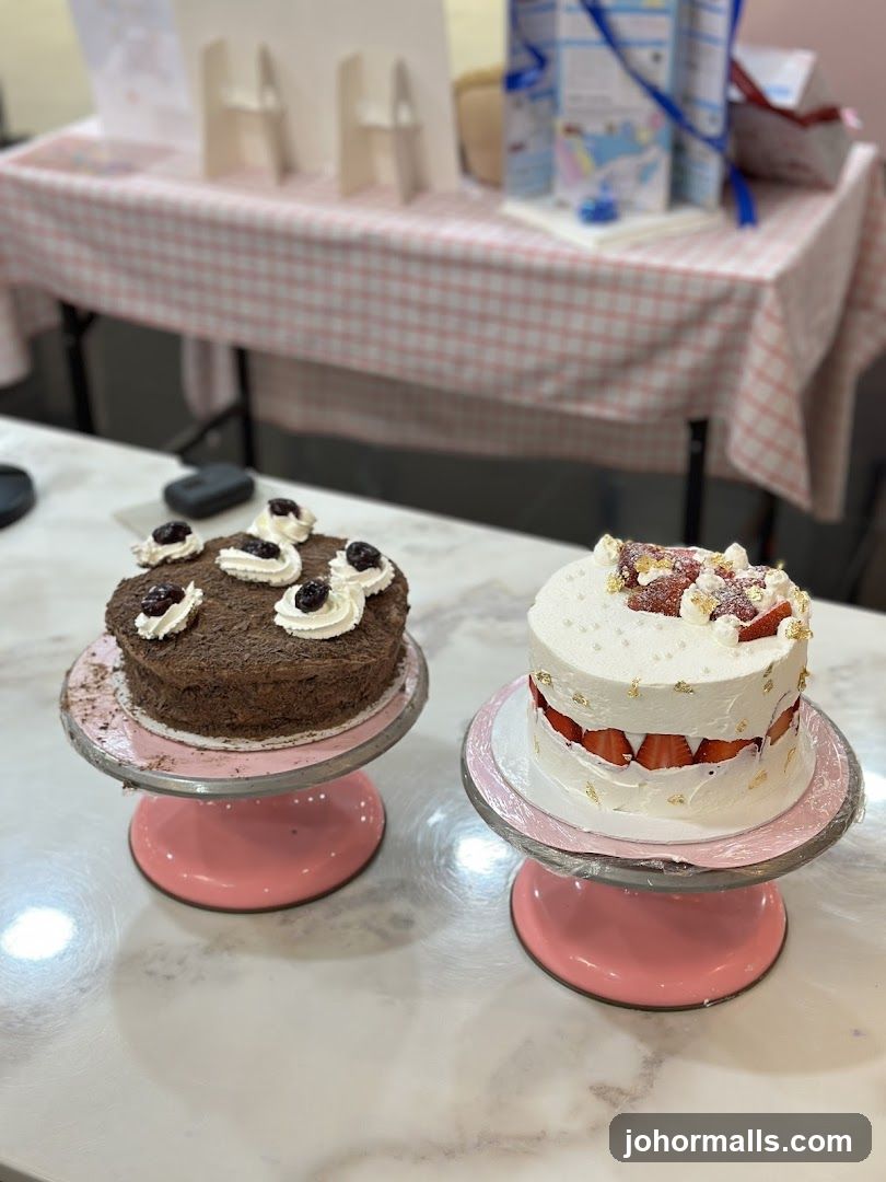 Two decorated cakes on display stands