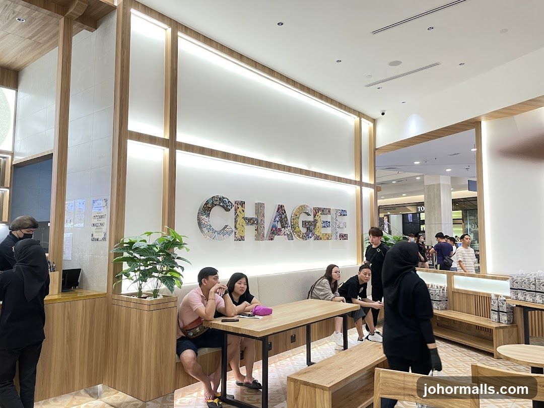 Interior of a modern cafe with seating and signage